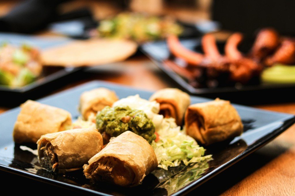 Quesabirria tacos with consommé dipping broth, lime and cilantro at Tequila Fuego Longview Washington